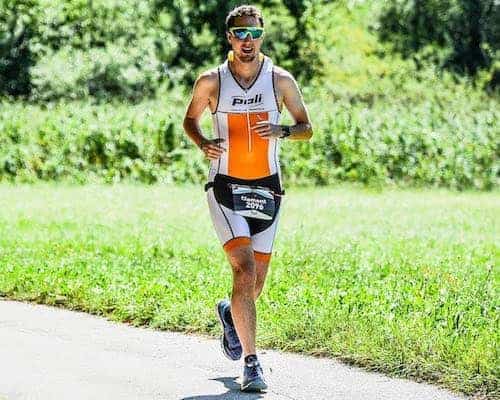 Clément running with a one-piece tri suit